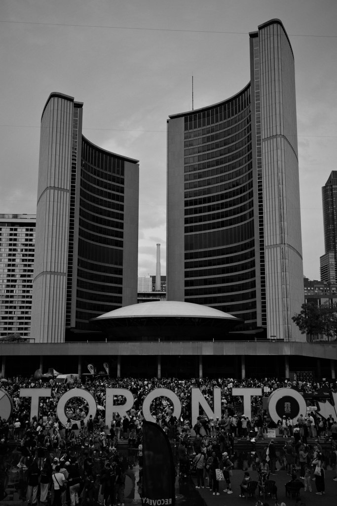 A crowd gathered in the public square below Toronto City Hall