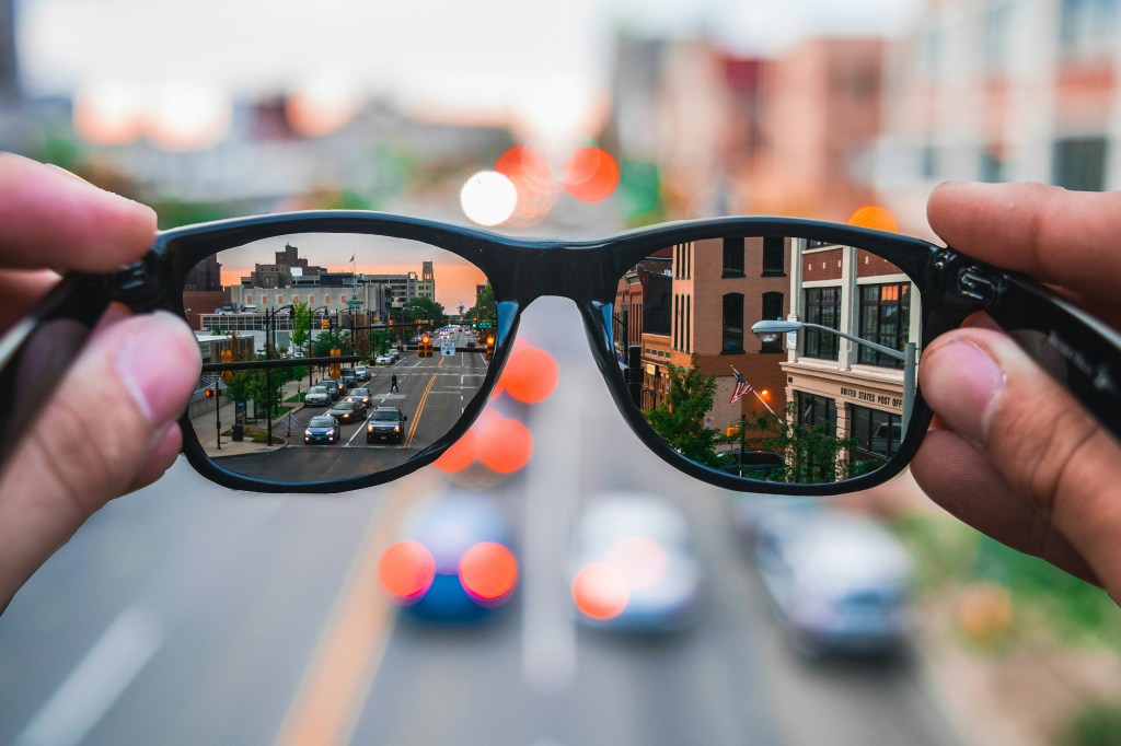 A highway reflected in the lenses of a pair of sunglasses